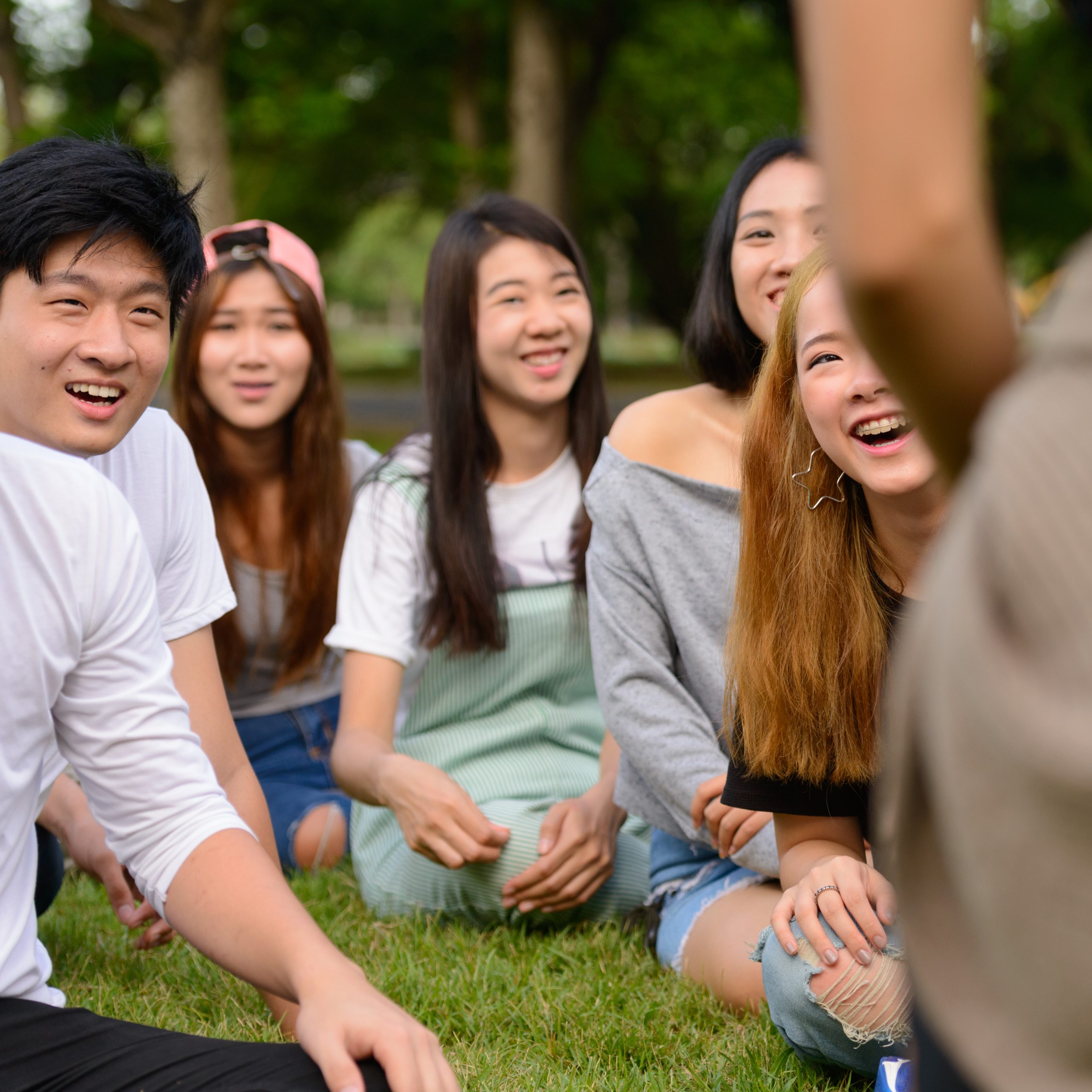 Happy young group of friends having fun together at the park