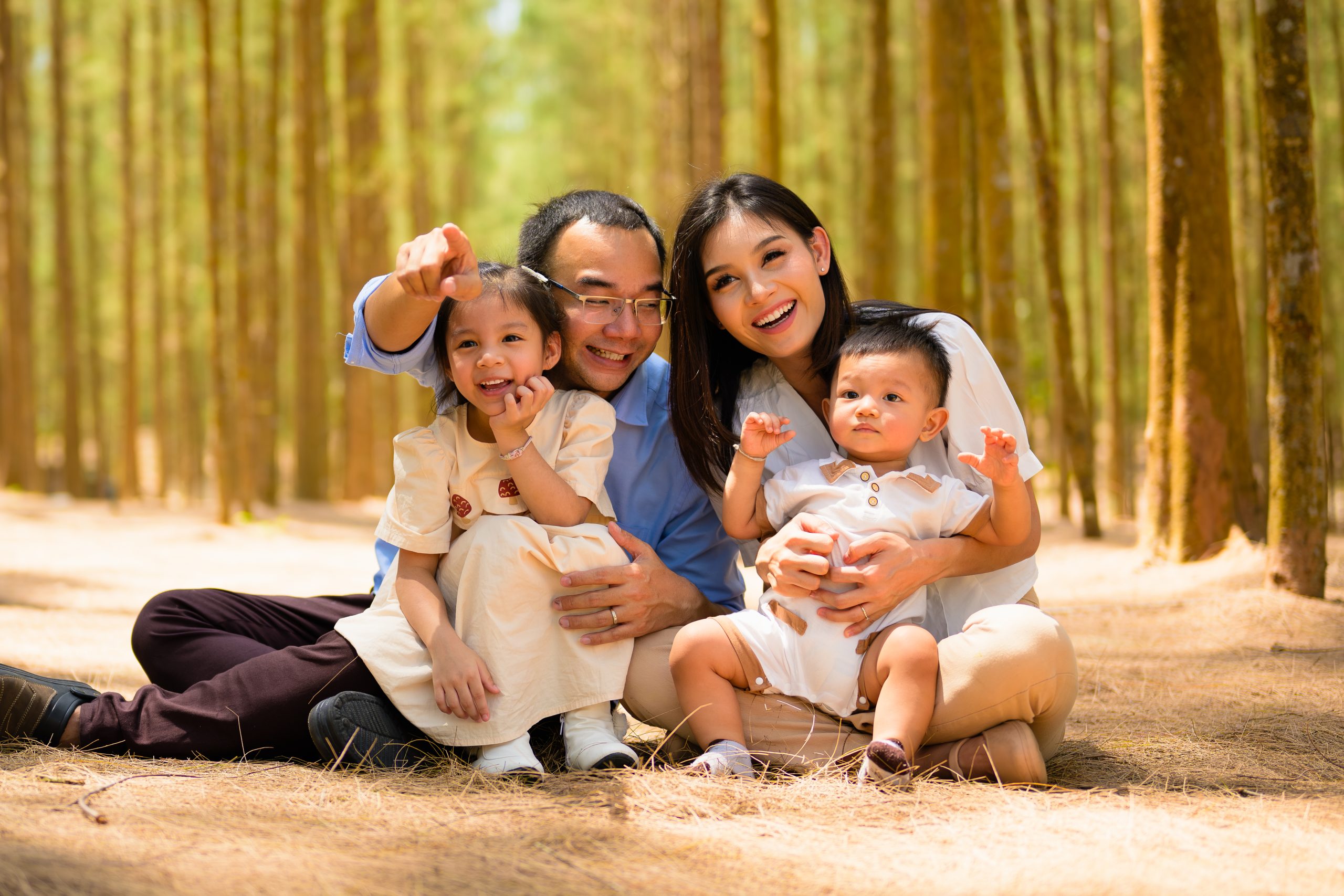 Smiling father and mother spending travel time with children at park
